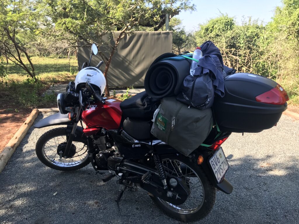 Motorcycle laden with luggage arriving to help rural entrepreneurs with free websites.