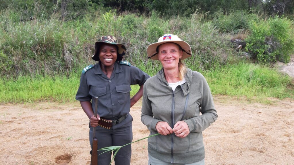 Bridgett with a game guide on safari in a tourist and conservation rich area to help uplift rural businesses.